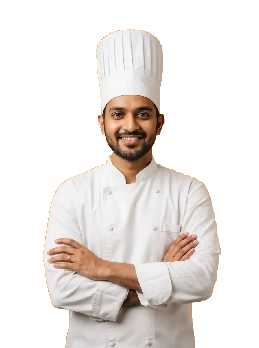 Smiling chef in a white uniform with arms crossed